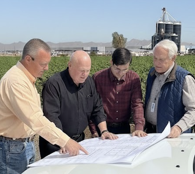 Thomas Williams reviewing project blueprints on site